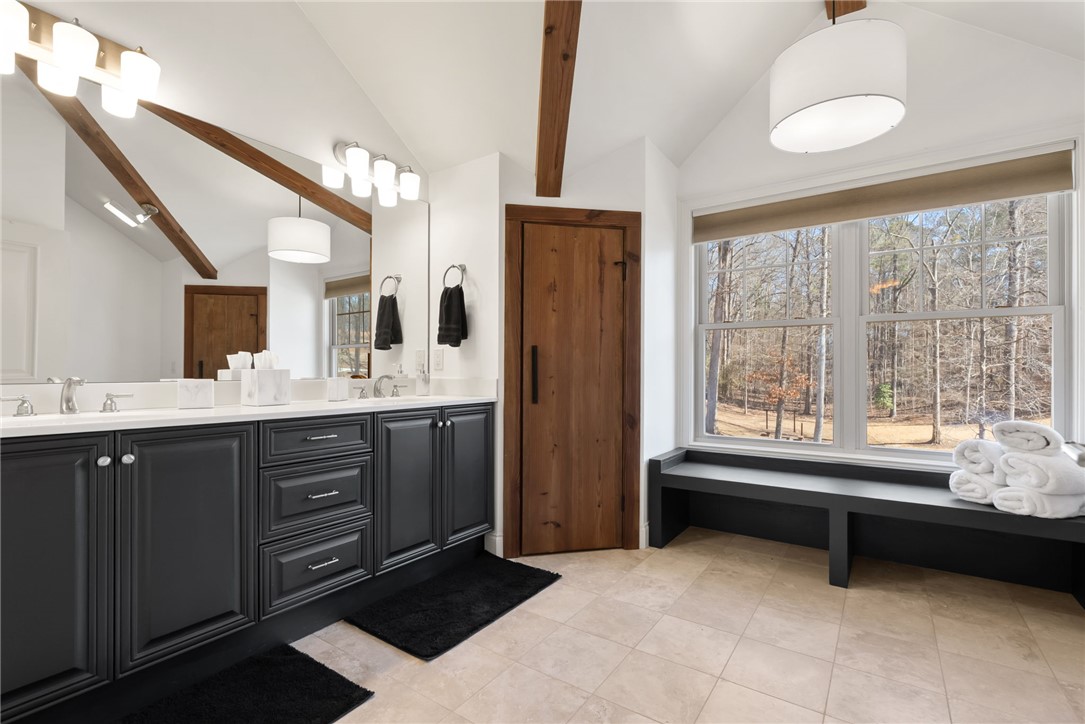 505 Northview Court Fair Play, SC 29643 - Photo 28 of 48 This primary bathroom features a double vanity and a large window offering expansive views of nature.