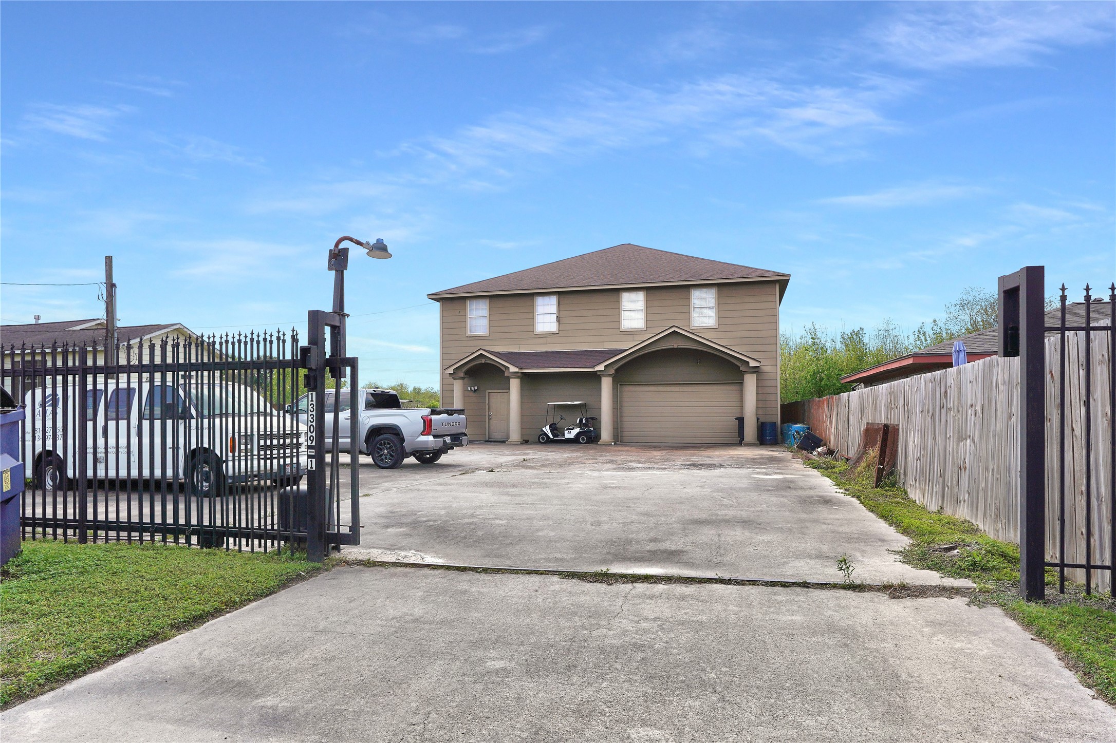 13301-13309 Reeveston Road Houston, TX 77039 - Photo 11 of 35 a front view of a house with a yard and garage