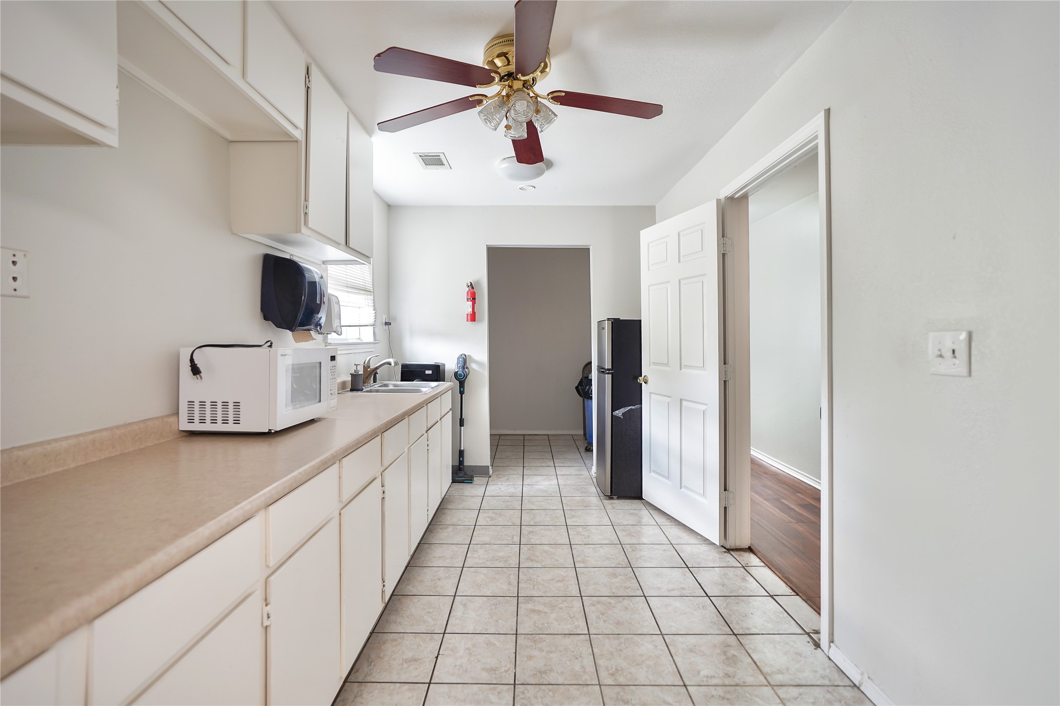 13301-13309 Reeveston Road Houston, TX 77039 - Photo 20 of 35 a kitchen with stainless steel appliances a sink and a refrigerator