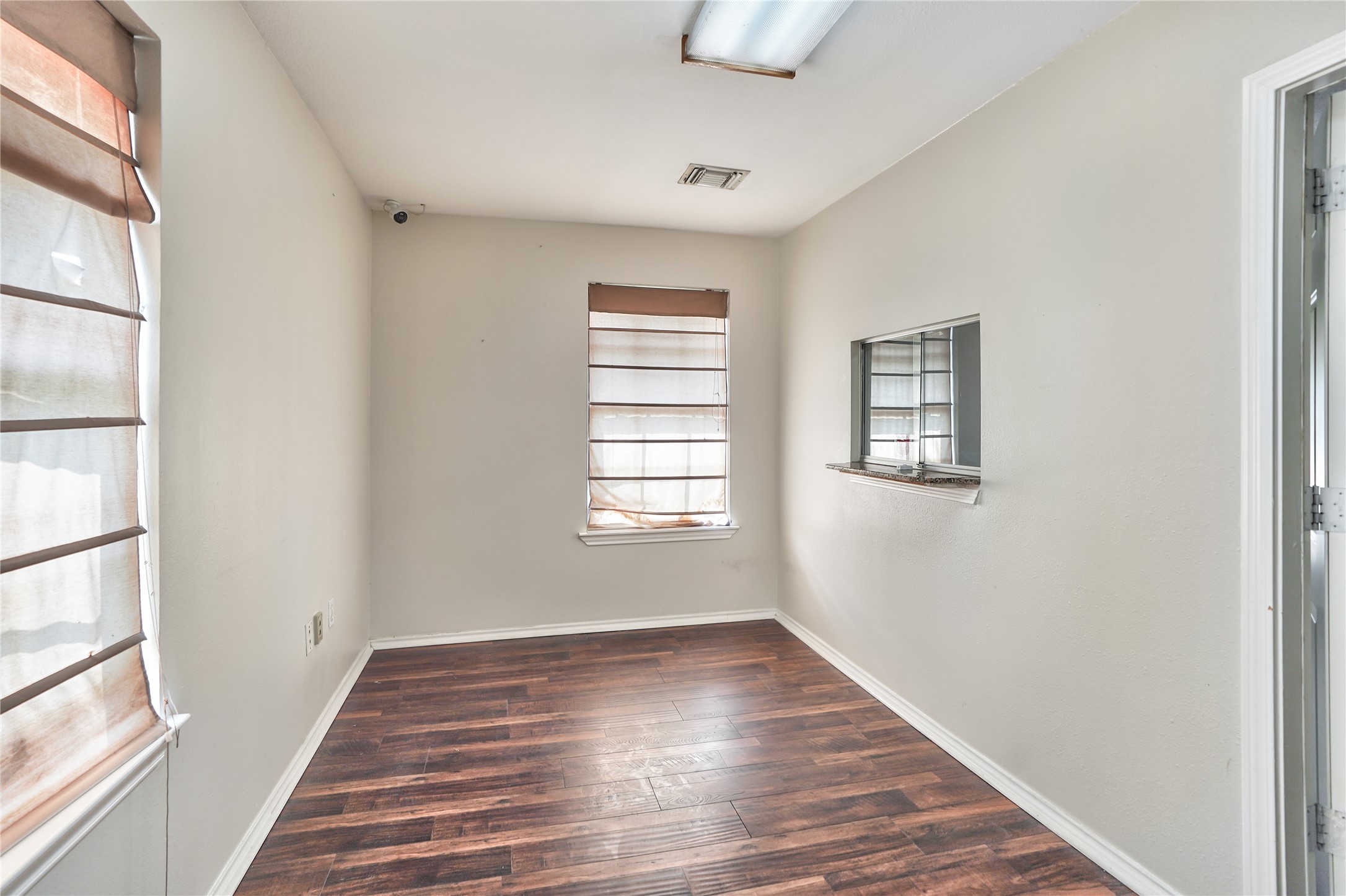 13301-13309 Reeveston Road Houston, TX 77039 - Photo 24 of 35 a view of an empty room with wooden floor and a window