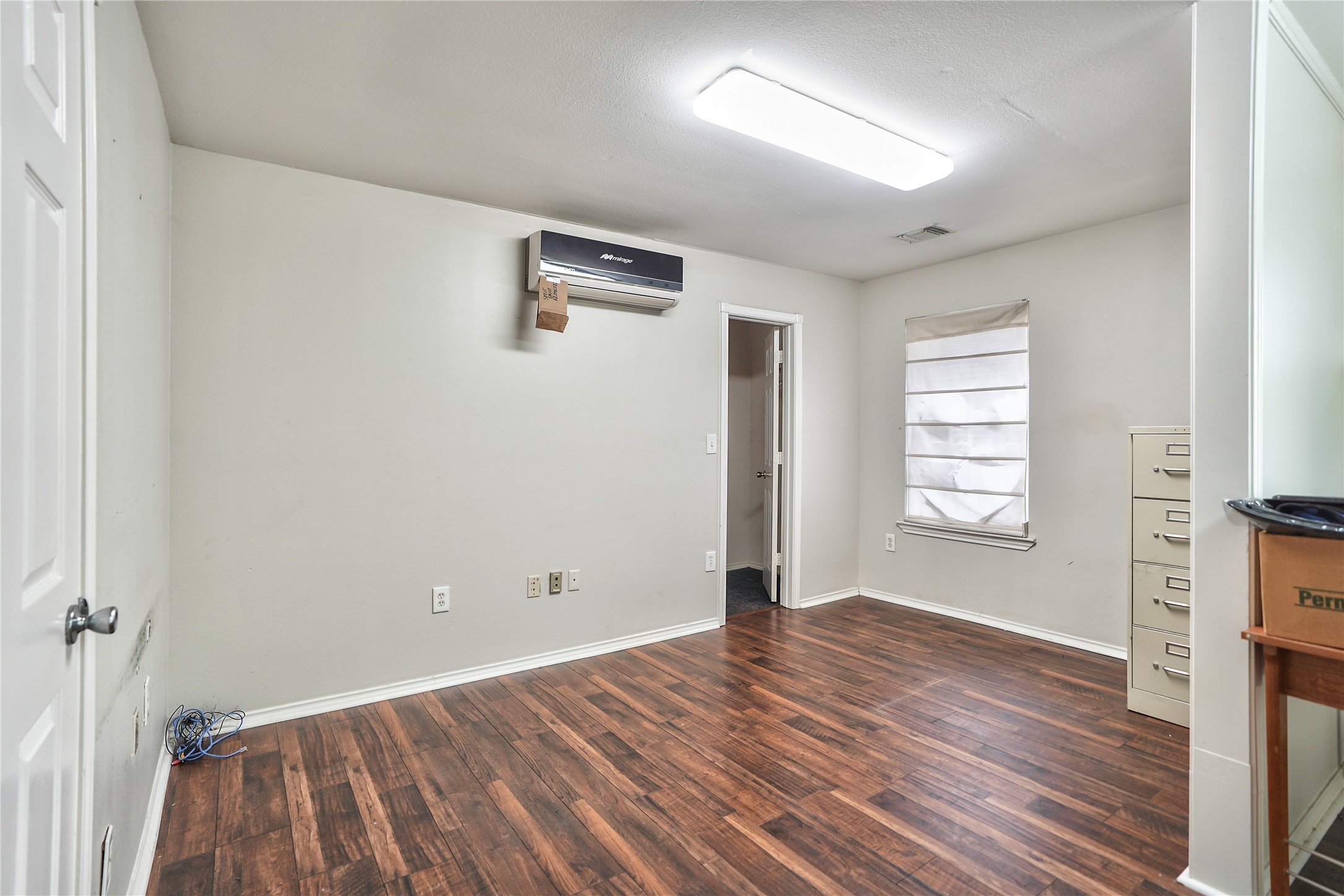 13301-13309 Reeveston Road Houston, TX 77039 - Photo 26 of 35 wooden floor in an empty room with a window