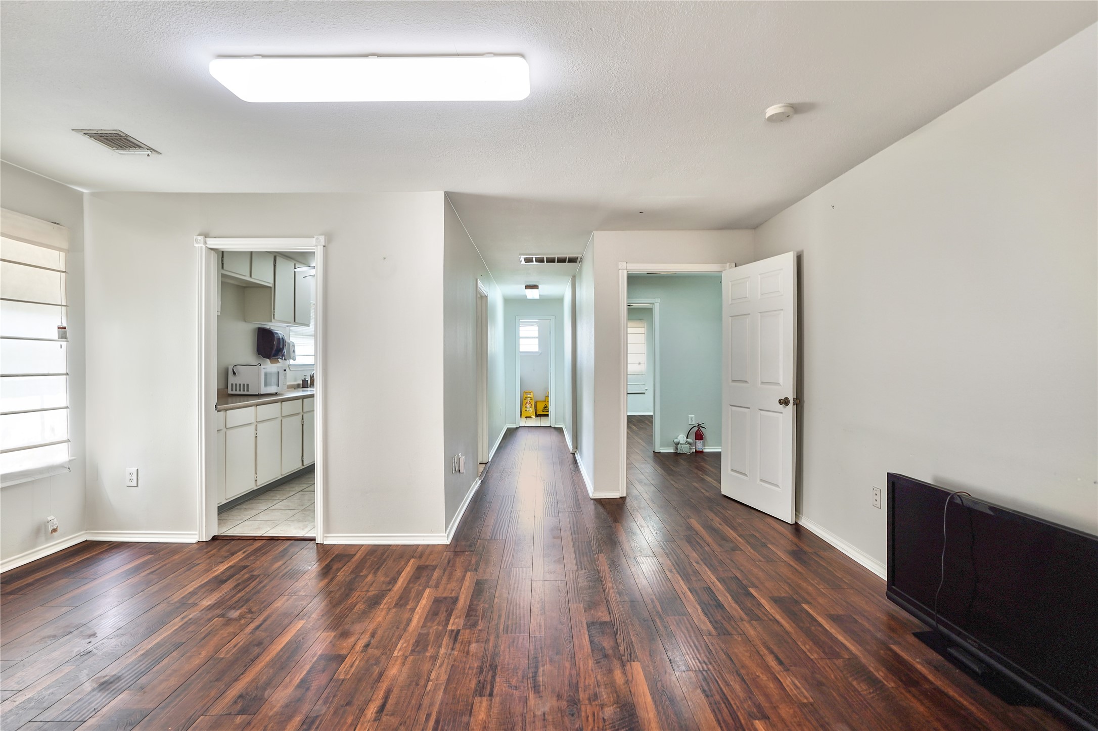 13301-13309 Reeveston Road Houston, TX 77039 - Photo 27 of 35 wooden floor in an empty room with a window