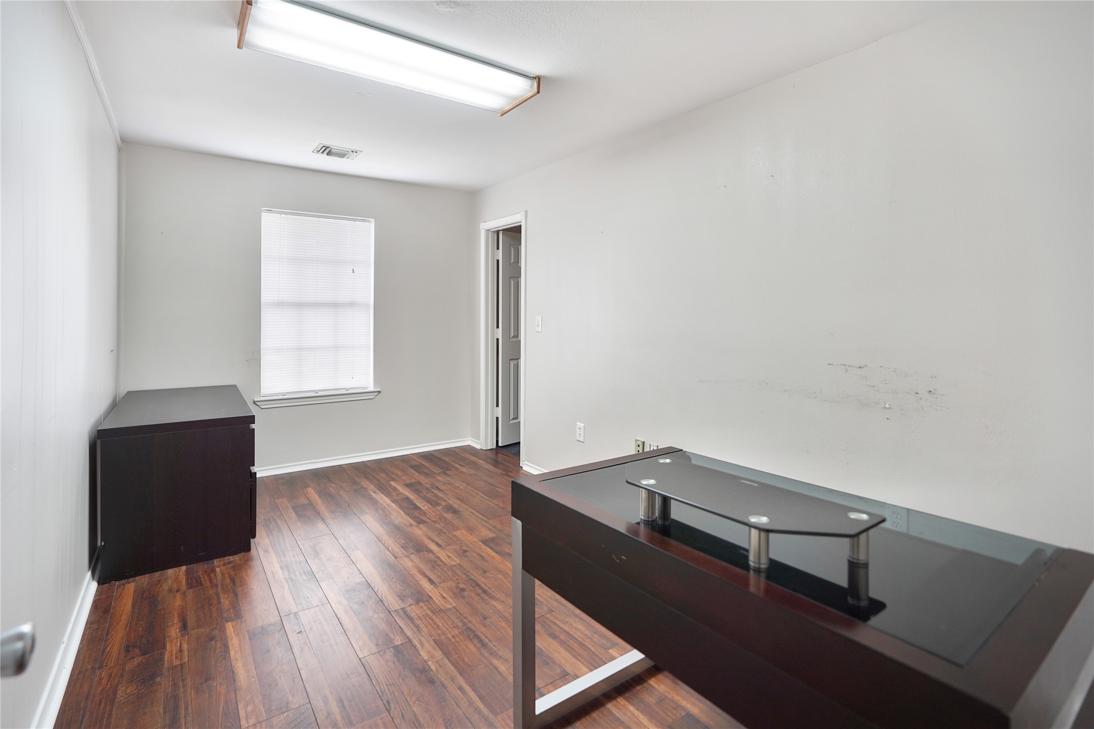 13301-13309 Reeveston Road Houston, TX 77039 - Photo 29 of 35 an empty room with wooden floor and windows