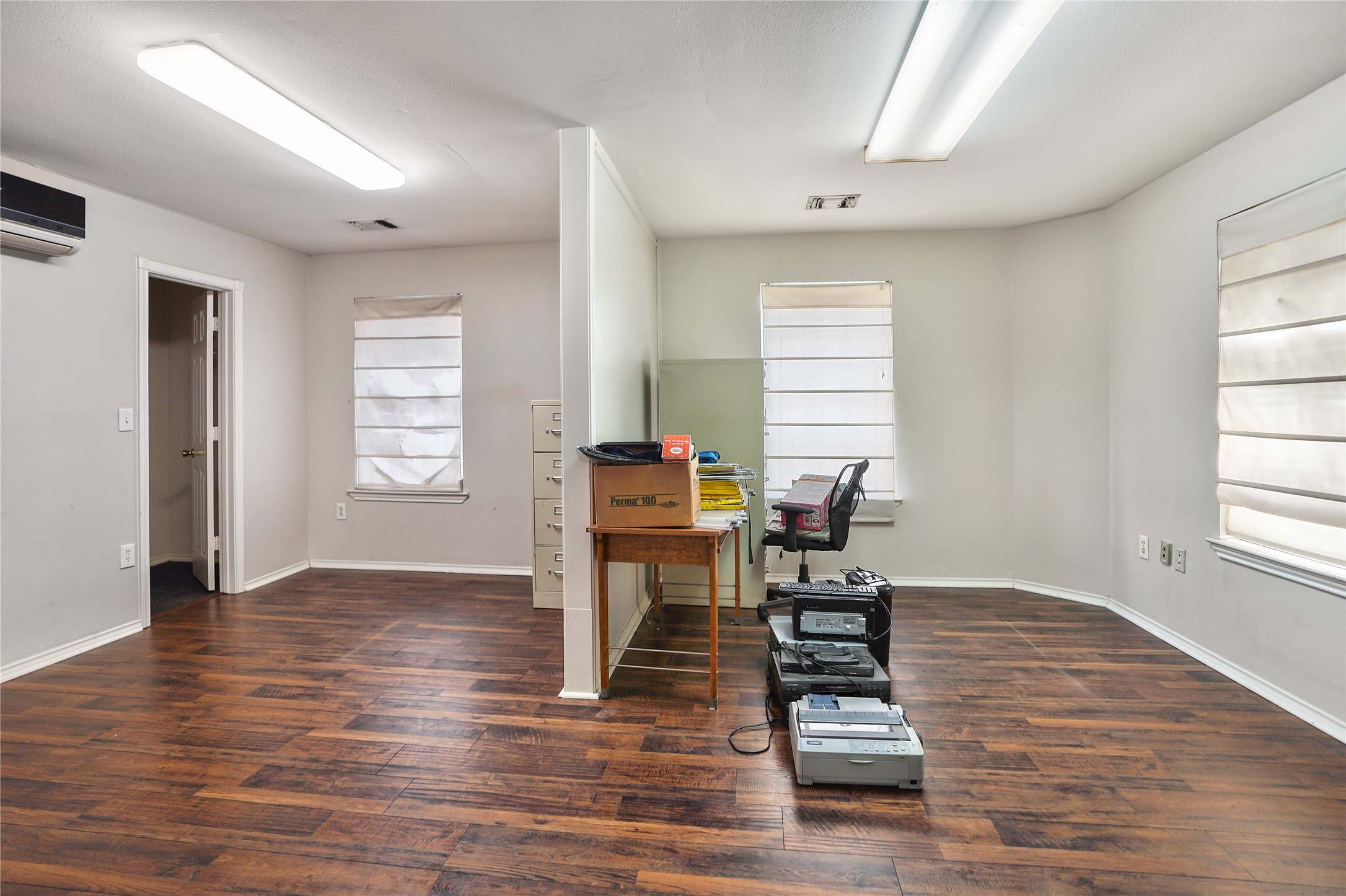 13301-13309 Reeveston Road Houston, TX 77039 - Photo 31 of 35 a workspace with wooden floor and a window