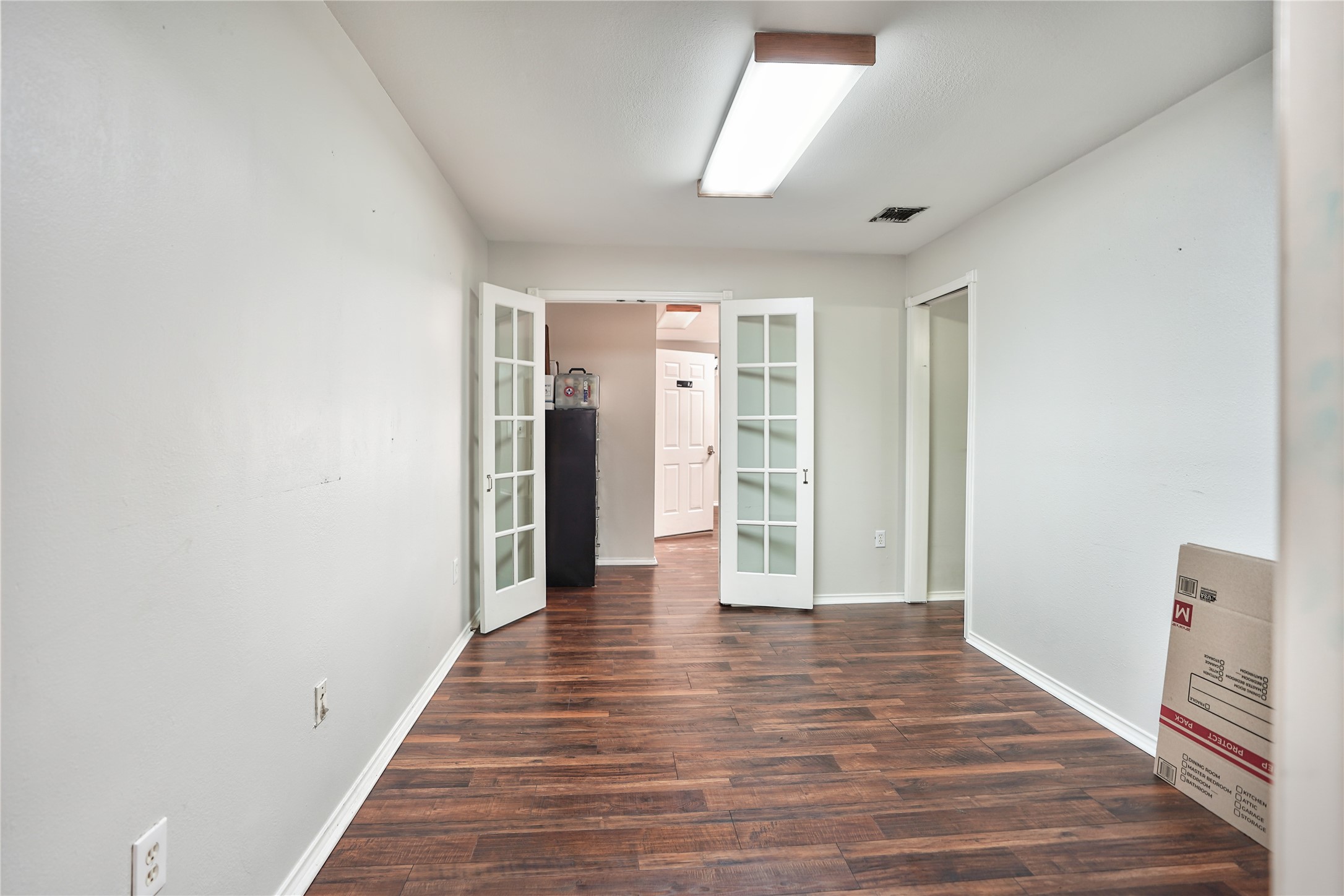 13301-13309 Reeveston Road Houston, TX 77039 - Photo 32 of 35 a view of an empty room with wooden floor and a window