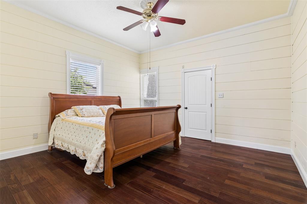 5824 Boone Street Sachse, TX 75048 - Photo 21 of 40 a bedroom with a bed and wooden floor