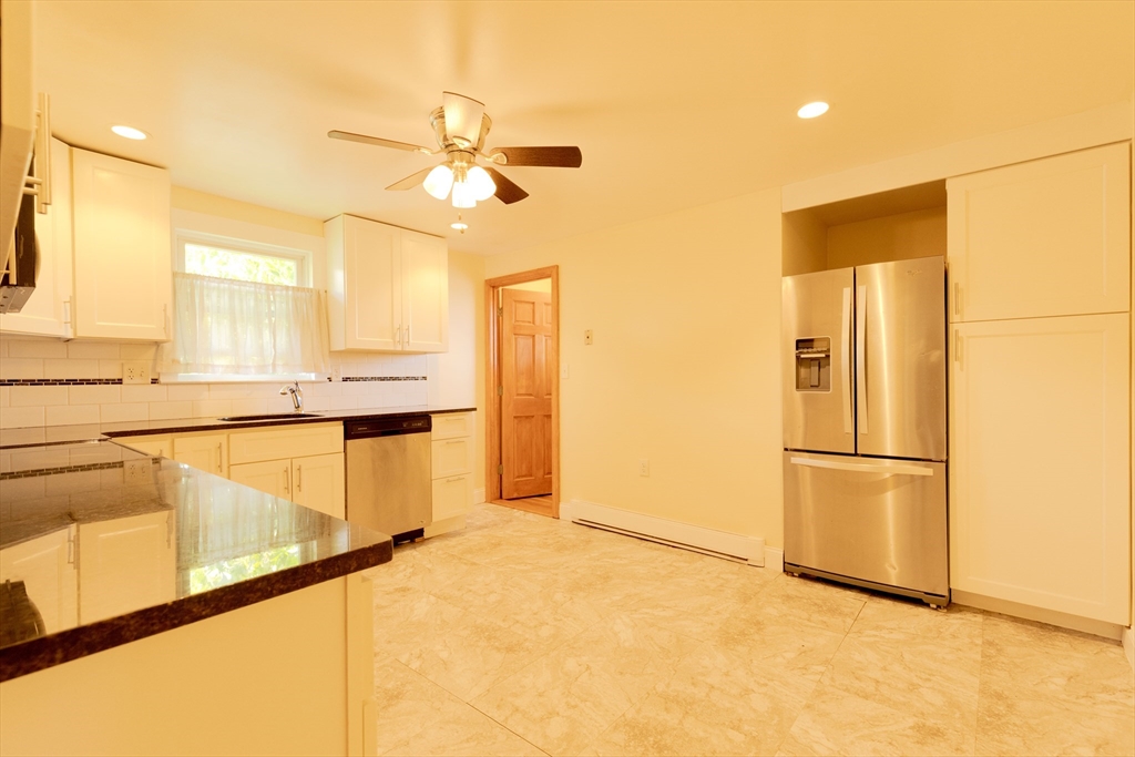 89 Brayton Road, Unit 2 Boston, MA 02135 - Photo 25 of 29 a view of a kitchen with a stove and a refrigerator