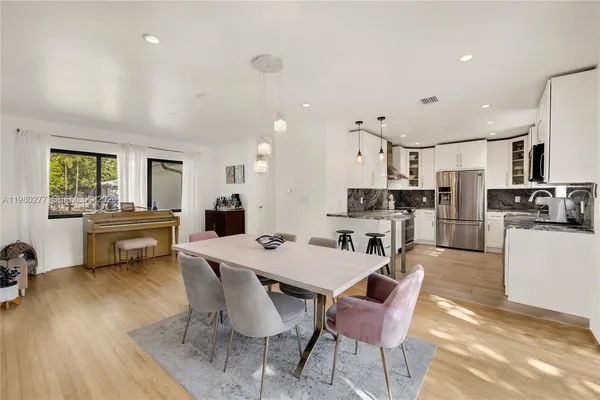 a view of a dining room with furniture and wooden floor