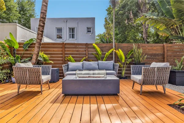 a view of a patio with a table and chairs under an umbrella