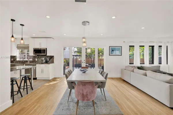 a view of a dining room with furniture window and wooden floor