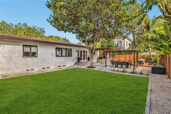 a front view of a house with patio and garden