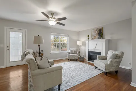 a living room with furniture and a view of kitchen
