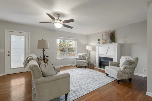 a living room with furniture and a view of kitchen