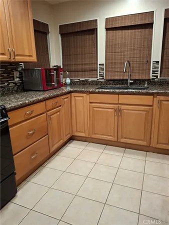 a kitchen with stainless steel appliances granite countertop a stove sink and cabinets