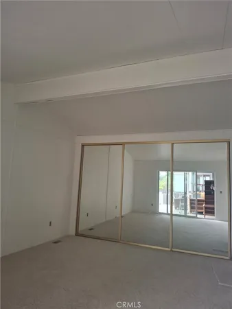 a view of an empty room and a window