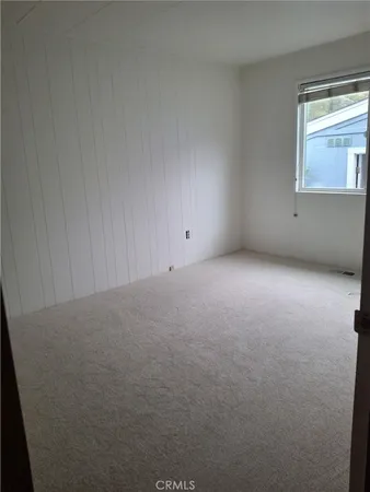 a view of an empty room with a fireplace