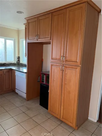 a view of a kitchen with wooden cabinets