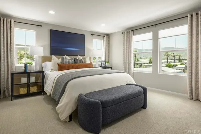 a bedroom with a bed and a large window