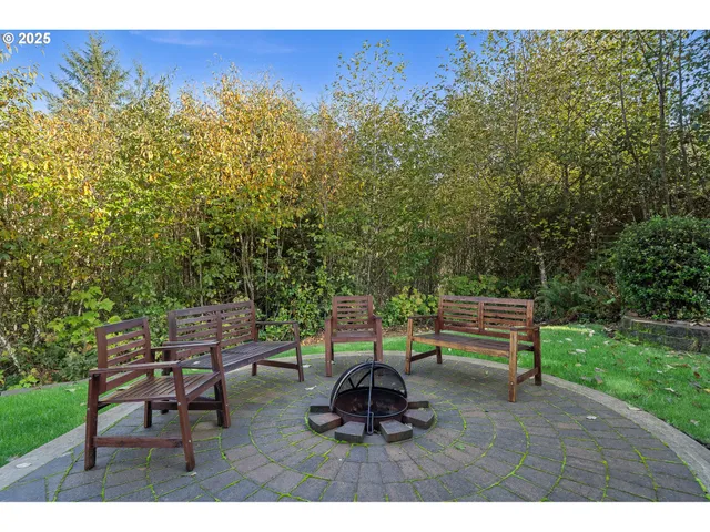 a backyard of a house with table and chairs