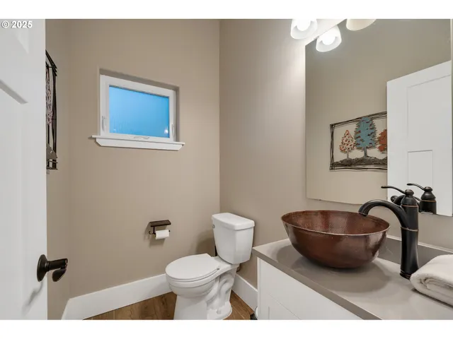 a bathroom with a toilet a sink and mirror