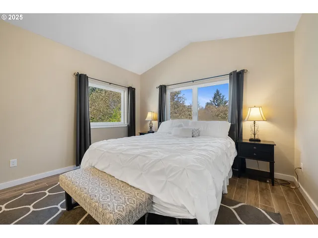 a bedroom with a bed and a painting on the wall