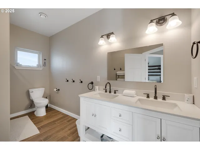 a bathroom with a sink mirror and toilet