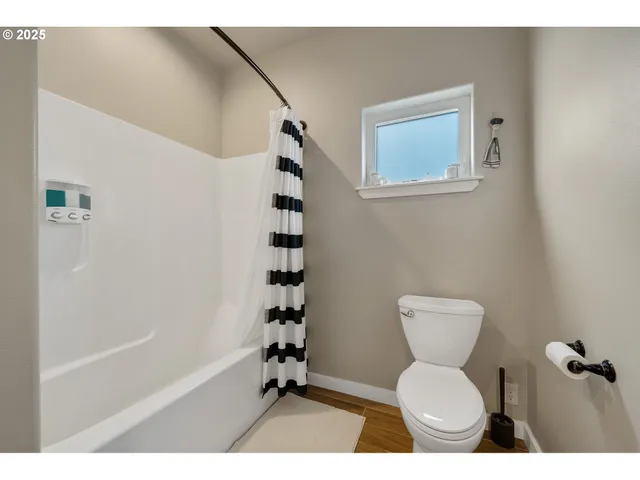 a bathroom with a toilet a sink and a shower