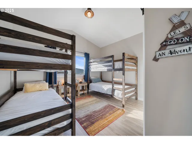 a bedroom with furniture and wooden floor