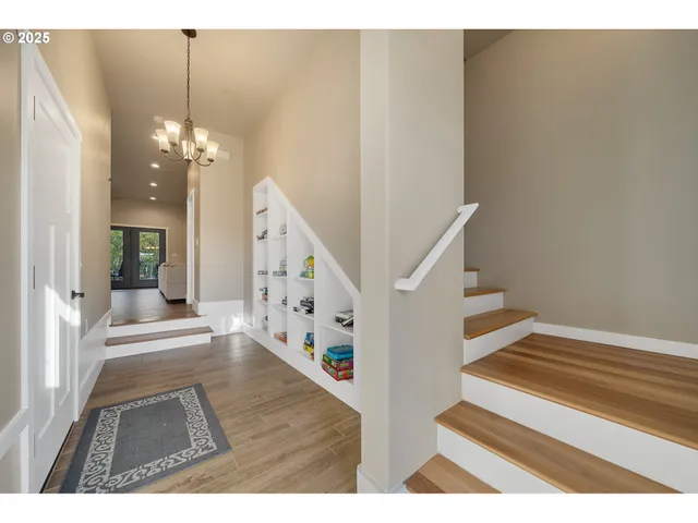 a view of entryway and hall with wooden floor