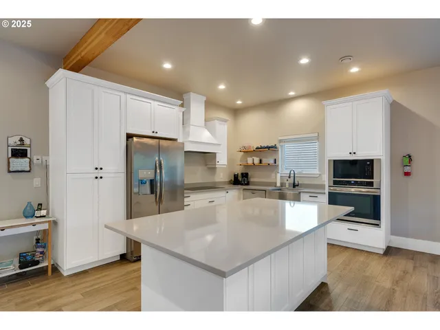 a kitchen with stainless steel appliances a refrigerator sink and microwave