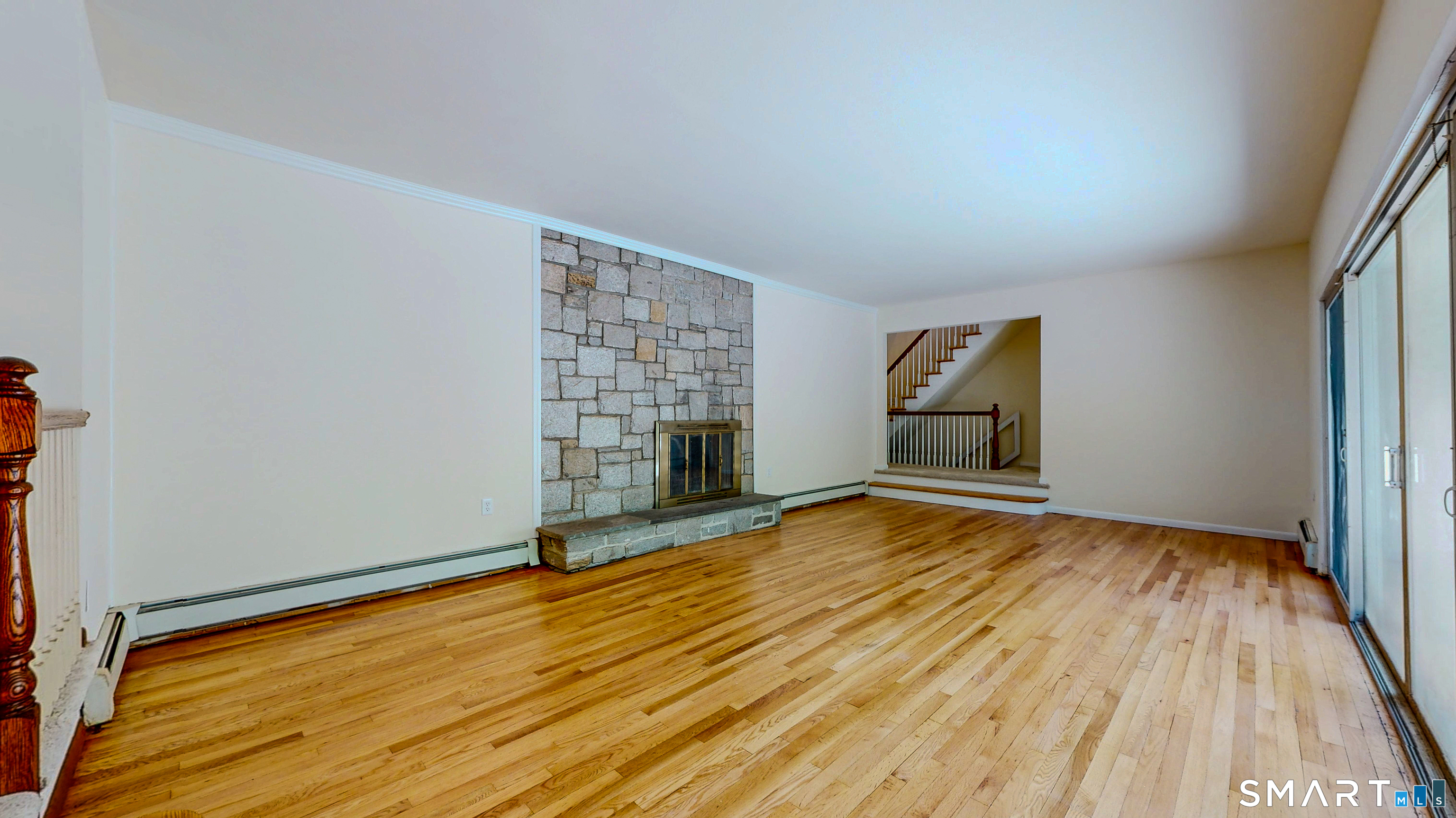 133 Chambers Road Danbury, CT 06811 - Photo 13 of 30 a view of empty room with wooden floor and fireplace