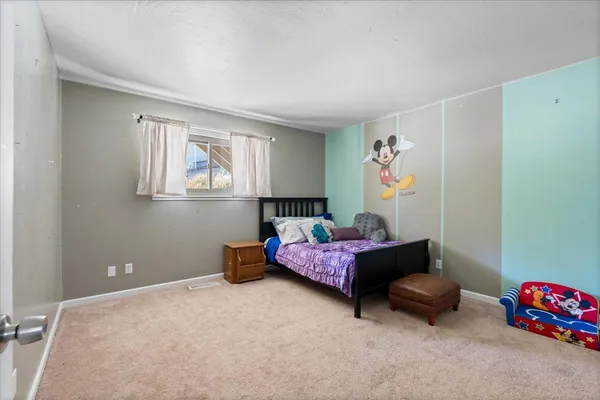 a bedroom with a bed and a chair