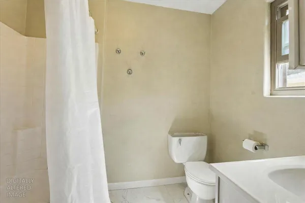 an aerial view of a house with a yard and trees