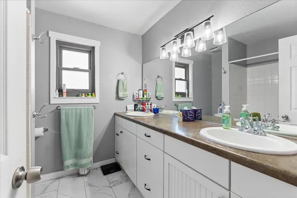 an aerial view of a house with a yard and trees