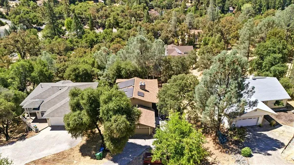 an aerial view of a house with outdoor space and sitting area