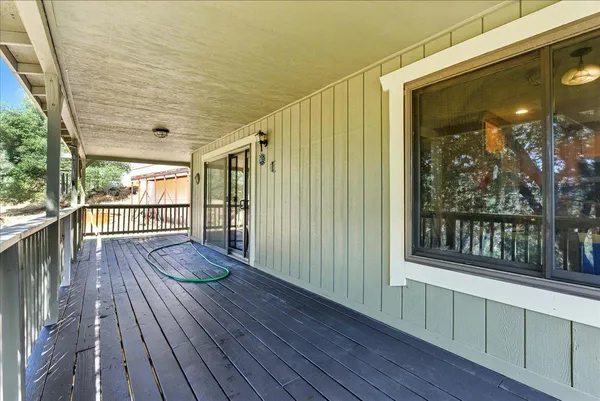 a view of a balcony with wooden floor