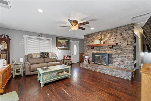 a living room with furniture and wooden floor