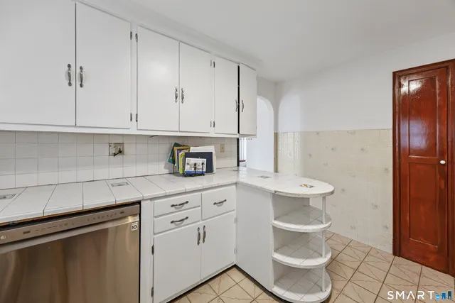 a kitchen with stainless steel appliances a white cabinets and a sink