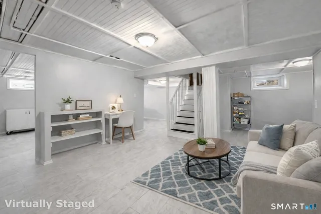 a living room with furniture a piano and a window