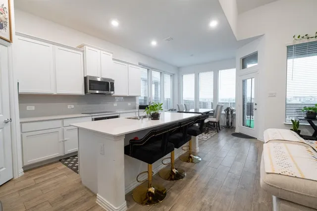 a kitchen with a sink a counter top space appliances and a window