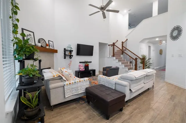 a living room with furniture and a potted plant