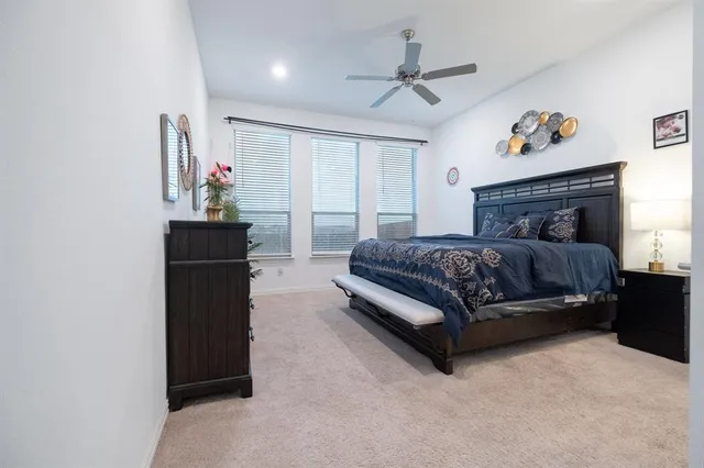 a spacious bedroom with a bed and window