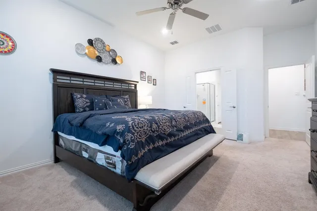 a bedroom with a bed and ceiling fan