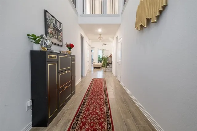 a view of hallway with wooden floor