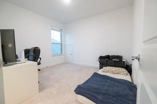 a bedroom with a bed and a chair