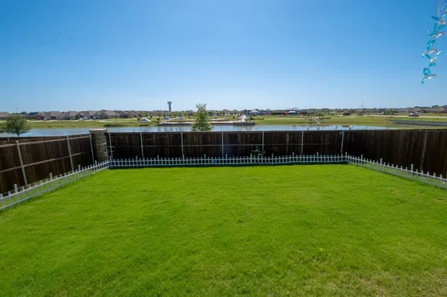 a view of a big yard with a lake view