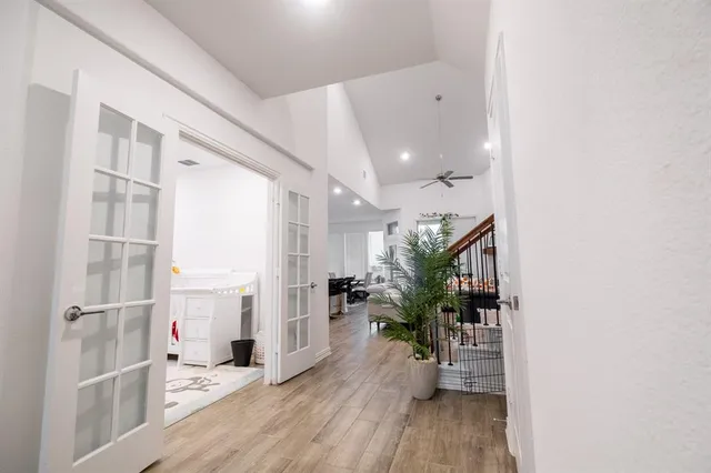 a view of a hallway view with wooden floor and a potted plant