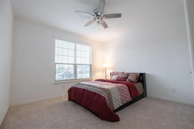 a spacious bedroom with a bed and window