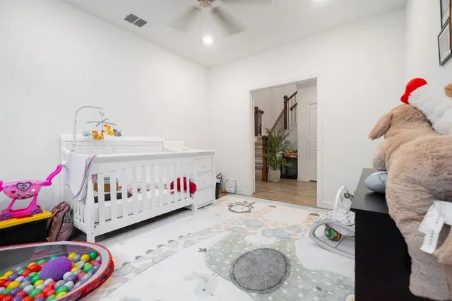 a bedroom with furniture and a baby crib