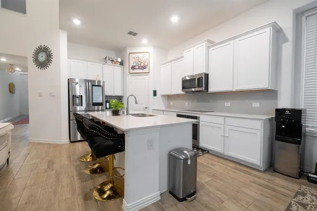 a kitchen with a sink appliances and cabinets